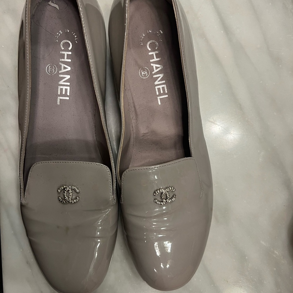 Chanel gray patent leather mocassin loafer with white beads on heel.